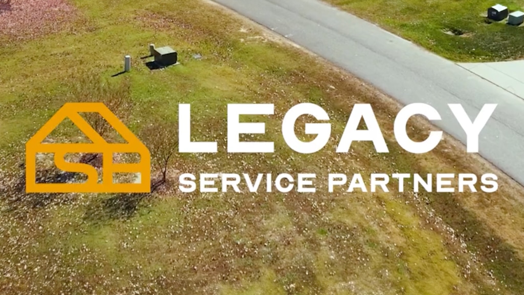 Mobile banner with service truck heading towards a home with the Legacy Service Partners logo.